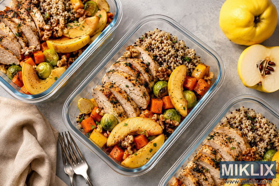 Top-down landscape photo of healthy meal prep containers filled with sliced grilled chicken breast, quinoa, roasted vegetables, walnuts, and fresh quince slices on a light gray surface with natural lighting. Top-down landscape photo of healthy meal prep containers filled with sliced grilled chicken breast, quinoa, roasted vegetables, walnuts, and fresh quince slices on a light gray surface with natural lighting.