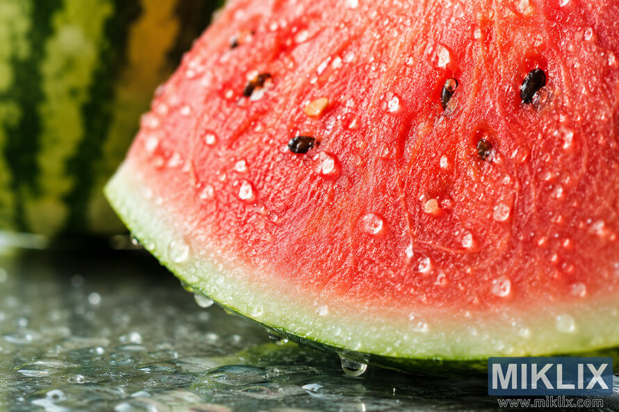 A high-resolution landscape macro photograph of a fresh watermelon slice covered with sparkling water droplets. The vivid red flesh, glossy black seeds, pale white rind, and green peel are shown in sharp detail against a softly blurred background, emphasizing freshness, juiciness, and natural hydration. A high-resolution landscape macro photograph of a fresh watermelon slice covered with sparkling water droplets. The vivid red flesh, glossy black seeds, pale white rind, and green peel are shown in sharp detail against a softly blurred background, emphasizing freshness, juiciness, and natural hydration.
