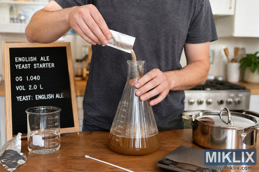 Homebrewer in a bright kitchen preparing a liquid yeast starter for English ale using an Erlenmeyer flask, brewing tools, and a recipe board on a wooden countertop. Homebrewer in a bright kitchen preparing a liquid yeast starter for English ale using an Erlenmeyer flask, brewing tools, and a recipe board on a wooden countertop.